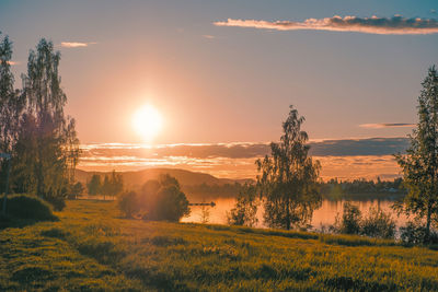 Scenic view of field against sky during sunset