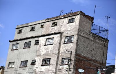 Low angle view of old building against blue sky