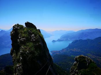 Scenic view of mountain range against blue sky