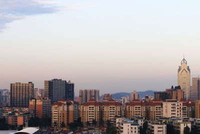 Buildings in city against clear sky