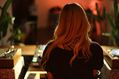 Rear view of woman standing at home