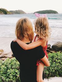 Mother and daughter looking at sea