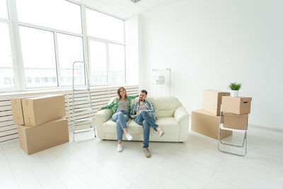 Women sitting on sofa at home