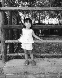 Full length portrait of cute girl standing outdoors