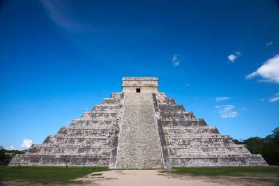 Low angle view of historical building against blue sky