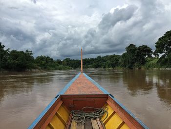 Pier on sea against cloudy sky