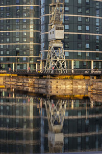 Reflection of industrial machinery at a dock