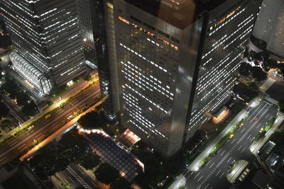 High angle view of illuminated buildings in city at night