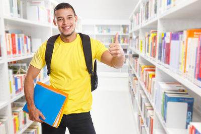 Portrait of smiling young man standing in corridor