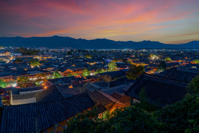 High angle view of illuminated buildings against sky during sunset