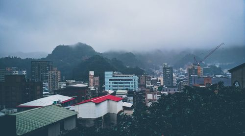 Buildings in city against sky