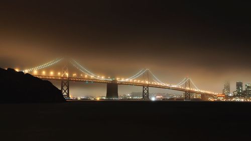 Illuminated suspension bridge at night