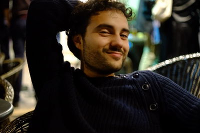 Portrait of man sitting on chair at cafe