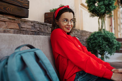 Portrait of smiling woman sitting outdoors