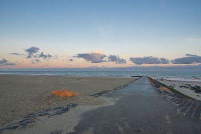 Scenic view of beach against sky during sunset