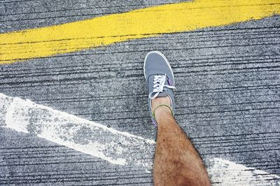 Low section of man standing on tiled floor