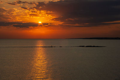 Scenic view of sea against orange sky