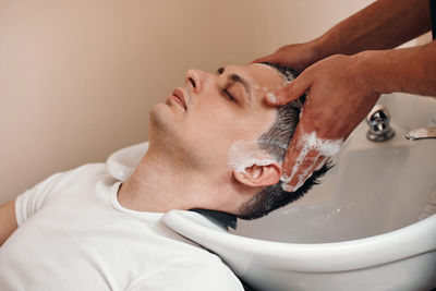 Close-up of man washing hands