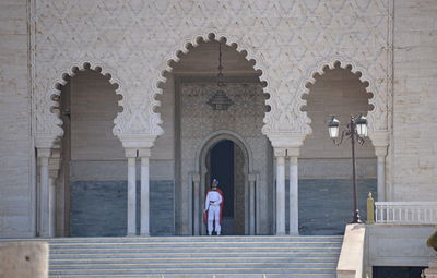 Rear view of man standing outside building