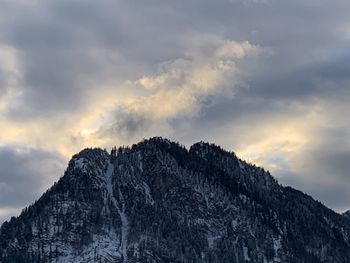 Low angle view of snowcapped mountain against sky