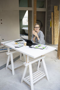 Portrait of young woman sitting on chair