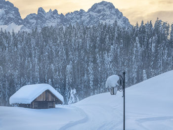 Snow covered land and mountains against sky