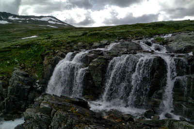 Scenic view of river flowing through rocks