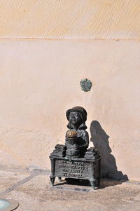 Statue against wall