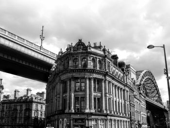 Low angle view of building against cloudy sky