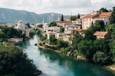 Bridge over river amidst buildings in town