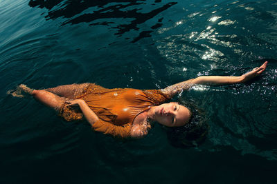 Young woman swimming in water