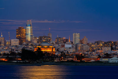 Illuminated city at waterfront