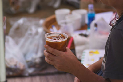 Cropped image of woman holding coffee cup