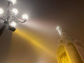 Low angle view of illuminated street light against sky at night