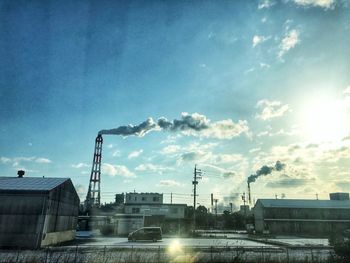 Factory against sky in city