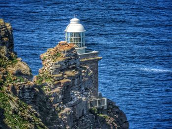 High angle view of lighthouse by sea against sky