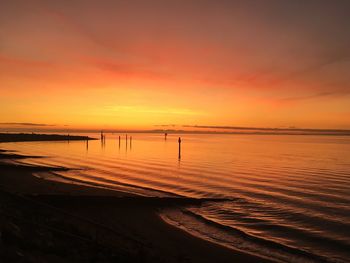 Scenic view of sea against romantic sky at sunset