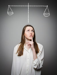 Portrait of a young woman looking up over white background