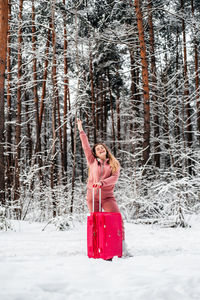 Woman standing on snow covered land