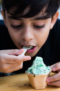 Close up portrait of boy eating ice cream