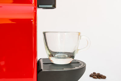 Close-up of wineglass on table against white background