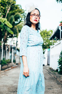 Portrait of young woman standing outdoors