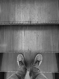 Low section of man standing on metal