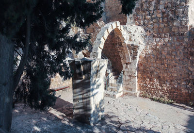 Built structure against trees and wall