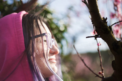 Close-up of woman looking at tree