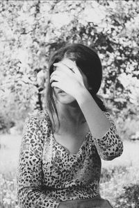 Close-up of young woman with eyes closed standing outdoors