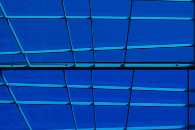 Low angle view of clear blue sky seen through skylight