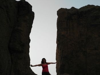 Rear view of woman standing against clear sky