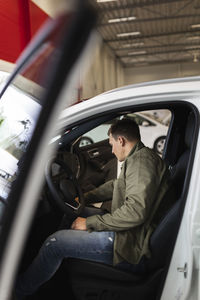 Customer trying car in car dealership office