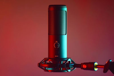 Close-up of microphone against yellow background